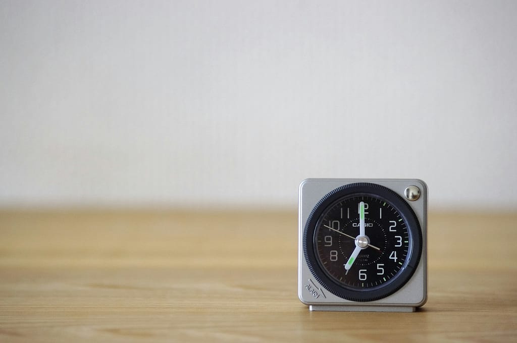 white and black analog desk clock