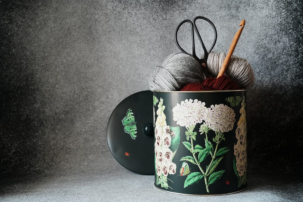 a crochet basket with yarn and a crochet hook