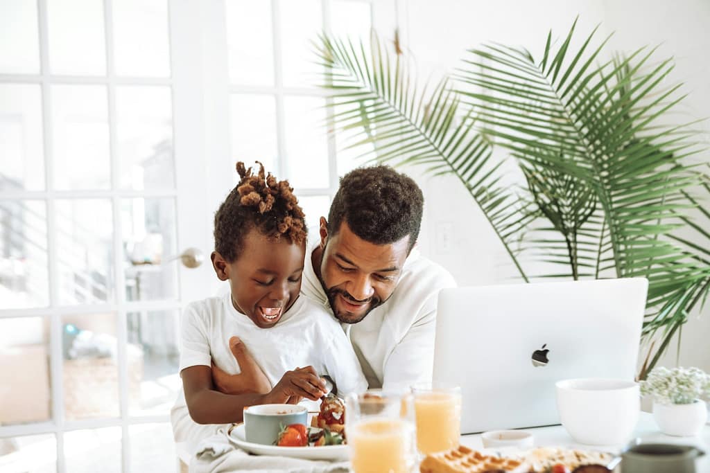 man and woman sitting on white couch
