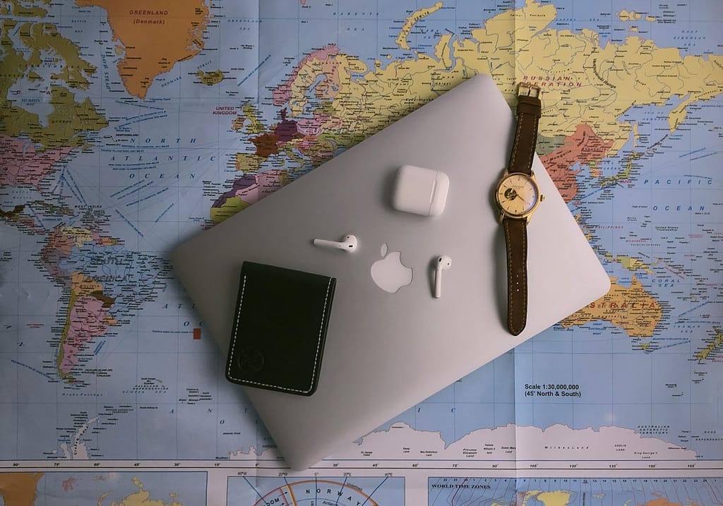 black ipad beside silver round analog watch
