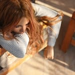 woman sleeping on brown armchair
