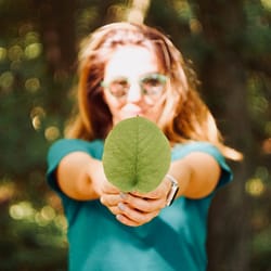 woman holding leaf