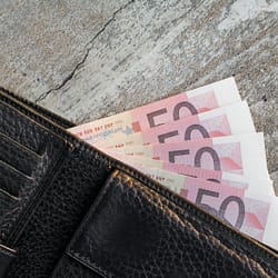 a wallet with a bunch of money sticking out of it