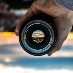 person holding black camera lens