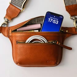 a brown purse with a blue tag